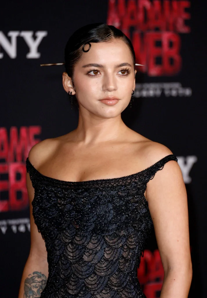 Isabela Merced smiling during a celebrity event representing her Latino heritage